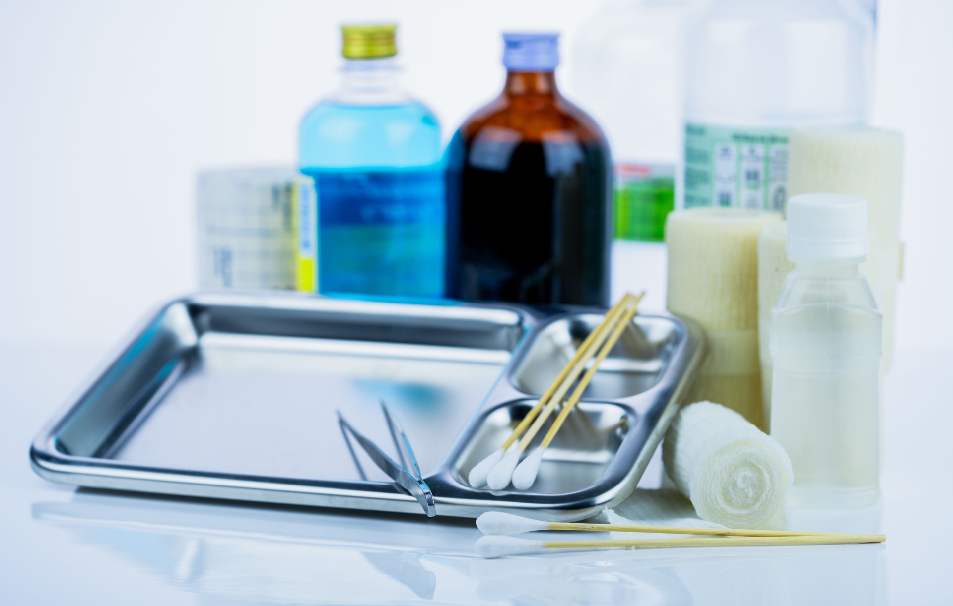 Medical equipment for treating infections. Wound care dressing set. Medical supplies for nurses. Conform bandage, forceps, cotton stick, alcohol. Sterile dressing materials. Healthcare equipment.
